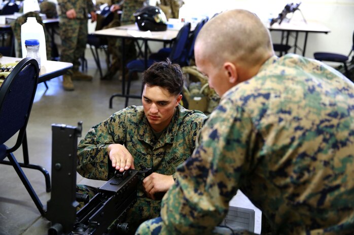 Marines with 1st Reconnaissance Battalion, work with a .50 caliber machine gun during a practical application exercise as part of the machine gunners course aboard Marine Corps Base Camp Pendleton, Calif., Feb. 27, 2014. During the eight-day course Marines learned the characteristics and the effective implementation of four weapon systems. The practical skills Marines learn during the course help enable them to be effective under a variety of combat scenarios.