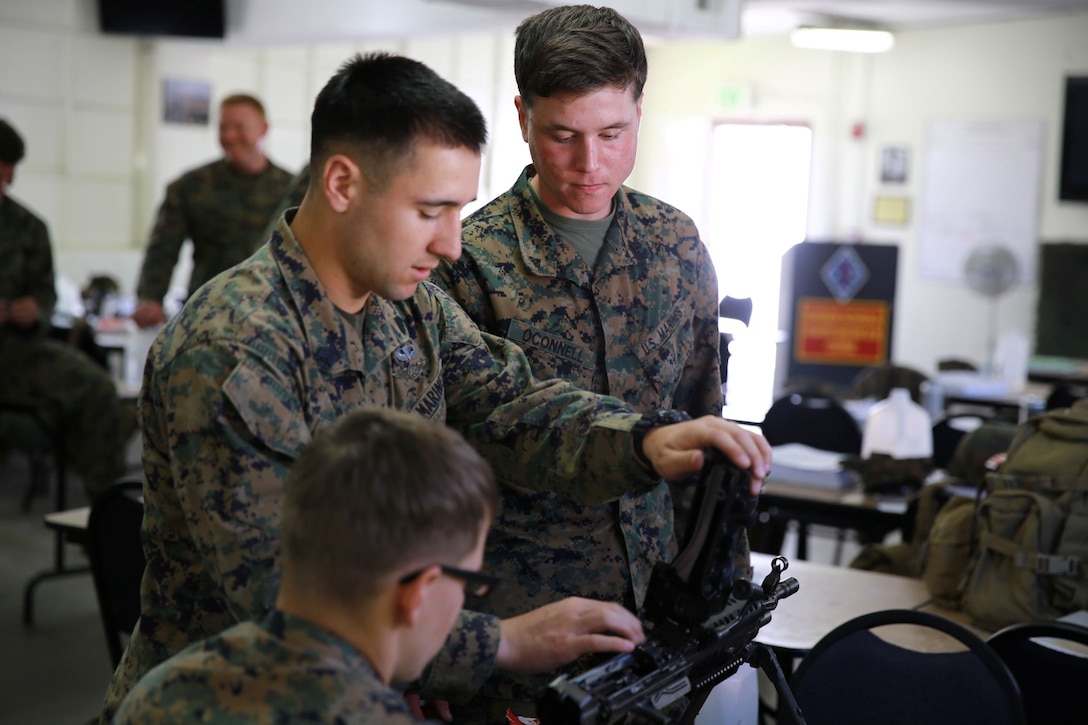 Marines with 1st Reconnaissance Battalion, work with a M249 weapon system during a practical application exercise as part of the machine gunners course aboard Marine Corps Base Camp Pendleton, Calif., Feb. 27, 2014. During the eight-day course Marines learned the characteristics and the effective implementation of four weapon systems. The practical skills Marines learn during the course help enable them to be effective under a variety of combat scenarios.