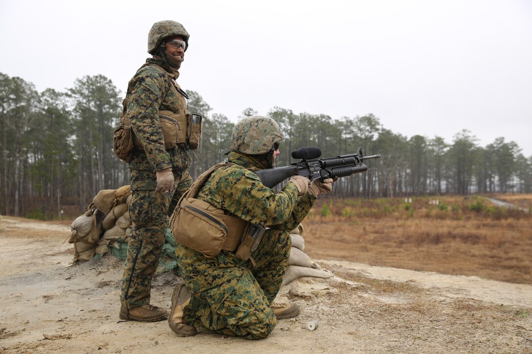 Cpl. Tyler A. Kluender prepares to fire an M-203 grenade launcher under the supervision of Sgt. Rico L. Roads during a live-fire range at Marine Corps Base Camp Lejeune, March 5, 2014. Kluender is a motor transportation operator and Roads is a gunner, both with Battery B, 2nd Low Altitude Air Defense Battalion. 