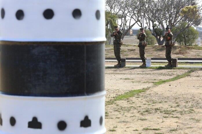 Recruits of Company H, 2nd Recruit Training Battalion, practice the standing position during Grass Week at Edson Range aboard Marine Corps Base Camp Pendleton, Calif., Feb. 19. Recruits aim and dry fire at the barrels with targets painted on it to simulate marksmanship qualification.