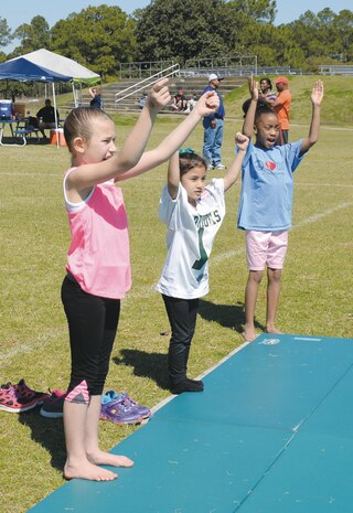 Girls practice cheer routines March 8 at MCLB Albany before the 2014 Lee County Warriors Youth Football and Cheer Camp. 