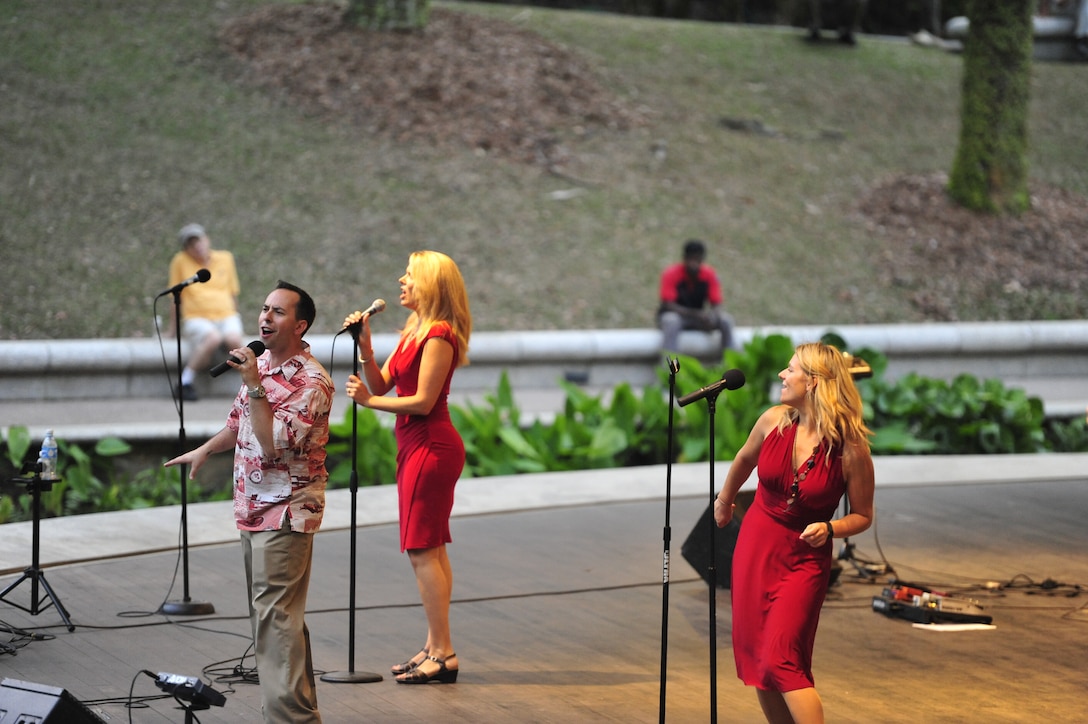 CHANGI, Singapore-- SrA Devin Rivas Martin sings " Locked Out Of Heaven", while MSgt Lara Murdzia and SSgt Courtney Clifford dance and sing background,  at the Singapore Botanic Garden, Feb. 15, 2014. The group played 9 shows to over 100K audience members throughout their tour. The Band of the Pacific-Hawaii went to Singapore in support of the air show, the U.S. Embassy, and to improve international relations. (US Air Force Photo/ SrA Andy Detra/released)