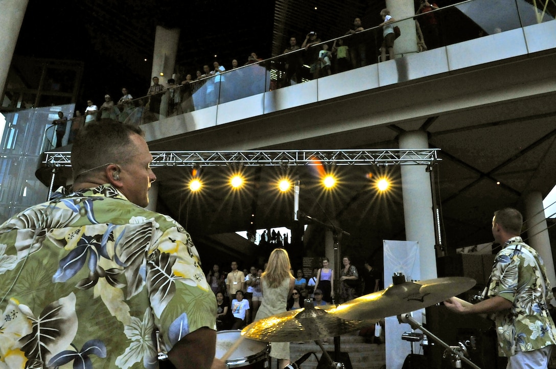 CHANGI, Singapore-- SSgt Troy Griffin, playing the kit, and MSgt Lara Murdzia, on vocals, plays to an intimate crowd as the sun sets at the Gardens By the Bay, Feb. 13, 2014. The group played 9 shows to over 100K audience members throughout their tour. The Band of the Pacific-Hawaii went to Singapore in support of the air show, the U.S. Embassy, and to improve international relations. (US Air Force Photo/ SrA Andy Detra/released)