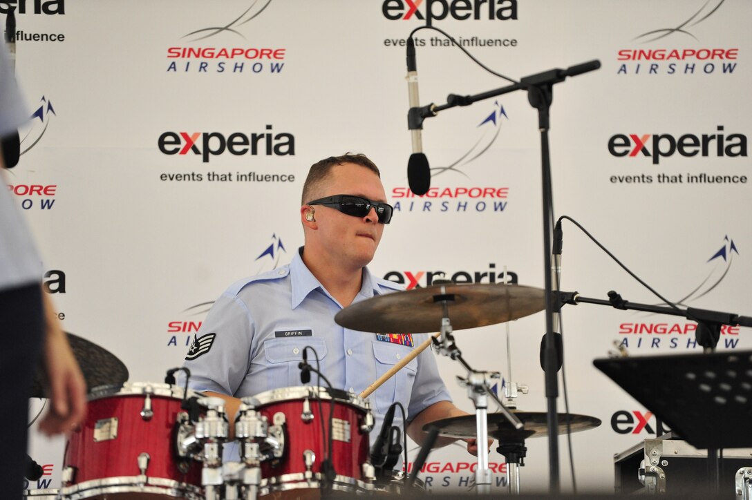 CHANGI, Singapore-- SSgt Troy Griffin plays a hip groove at the Singapore Air Show, Feb. 12, 2014. The group played 9 shows to over 100K audience members throughout their tour. The Band of the Pacific-Hawaii went to Singapore in support of the air show, the U.S. Embassy, and to improve international relations. (US Air Force Photo/ SrA Andy Detra/released)