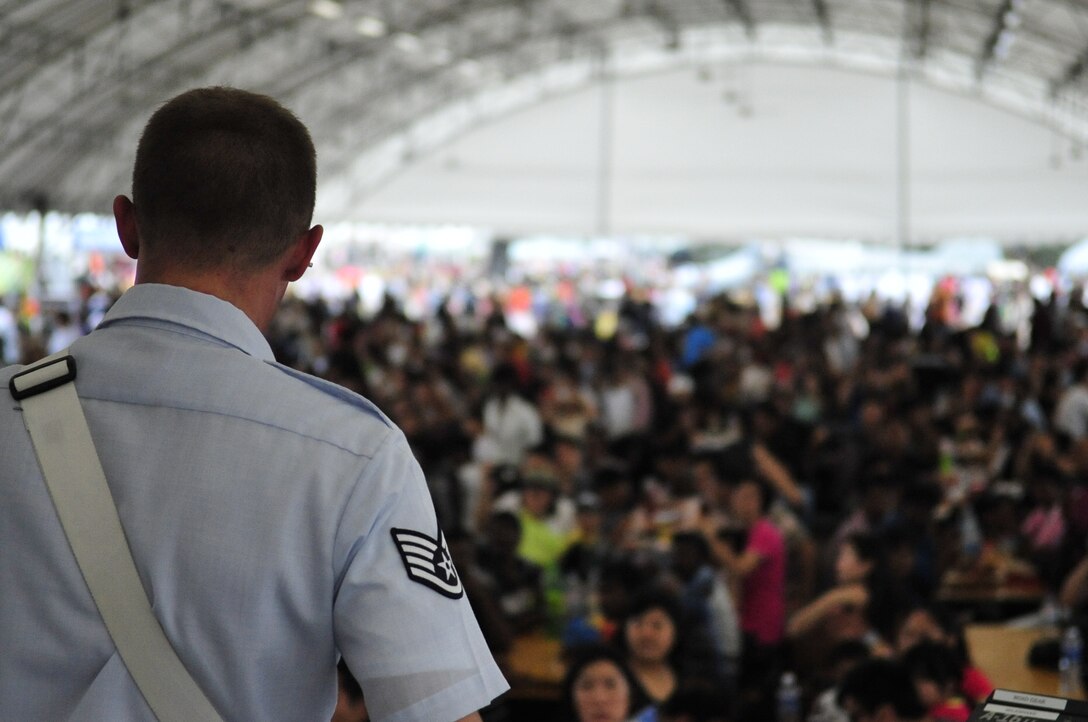 CHANGI, Singapore-- SSgt Aaron Kusterer, guitarist with the Band of the Pacific-Hawaii, performs a slamming guitar solo to a sea of people at the Singapore Air Show, Feb. 16, 2014. The group played 9 shows to over 100K audience members throughout their tour. The Band of the Pacific-Hawaii went to Singapore in support of the air show, the U.S. Embassy, and to improve international relations. (US Air Force Photo/ SrA Andy Detra/released)