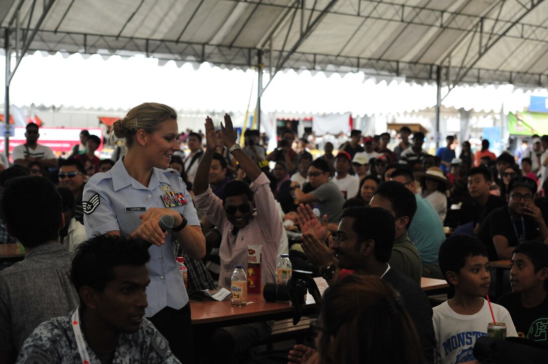 CHANGI, Singapore-- SSgt Courtney Clifford shows off her signature dance moves at the Singapore Air Show, Feb. 16, 2014.  The group played 9 shows to over 100K audience members throughout their tour. The Band of the Pacific-Hawaii went to Singapore in support of the air show, the U.S. Embassy, and to improve international relations. (US Air Force Photo/ SrA Andy Detra/released)