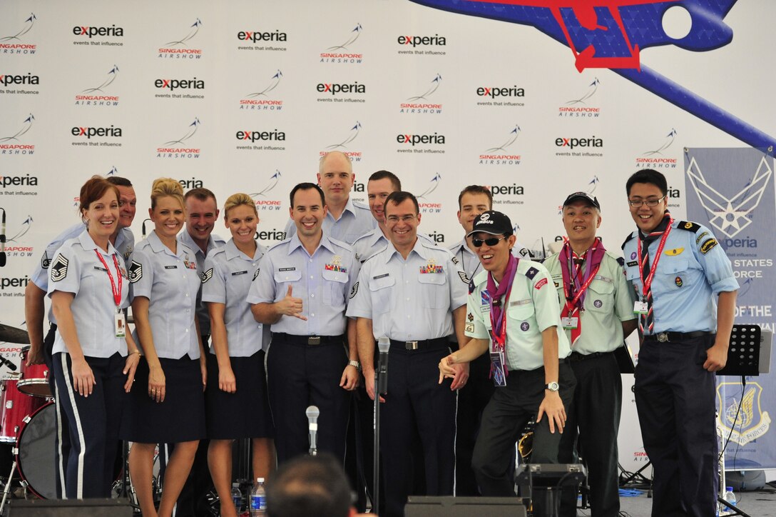 CHANGI, Singapore--  "Hana Hou!" poses with a few Singaporean Scouts after the show, Feb 12, 2014.The group played 9 shows to over 100K audience members throughout their tour. The Band of the Pacific-Hawaii went to Singapore in support of the air show, the U.S. Embassy, and to improve international relations. (US Air Force Photo/ SrA Andy Detra/released)
