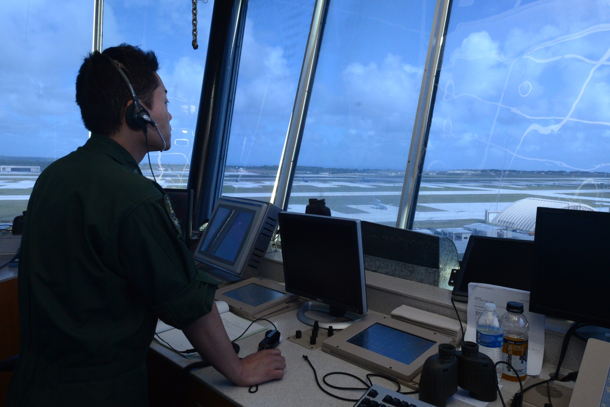 Japan Air Self-Defense Force Capt. Kenta Kikuchi, 204th Squadron F-15 pilot, observes operations for his nation’s aircraft taking off from Andersen Air Force Base, Guam Feb. 24, 2014, during Exercise Cope North 2014.The exercise, which is a joint effort between the U.S. Air Force, the Japan Air Self-Defense Force and the Royal Australian Air Force, is designed for allies to work together on both humanitarian assistance and disaster relief (HA/DR) missions as well as large force employment mission with dissimilar aircraft. (U.S. Air Force photo by Airman 1st Class Emily A. Bradley/Released)