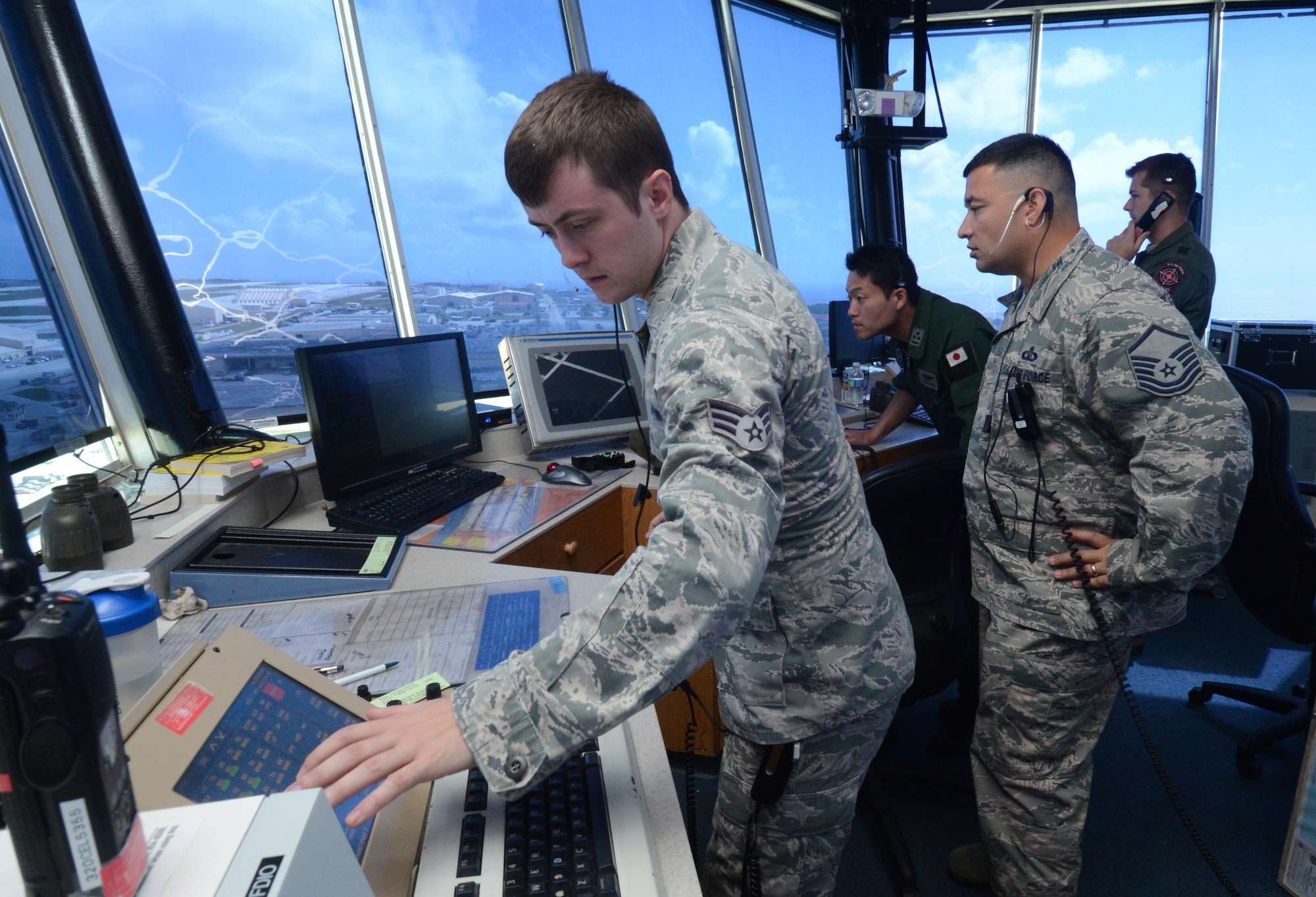 Senior Airman Michael-Paul Kendall, 36th Operations Support Squadron air traffic controller, monitors aircraft movements for Japan Air Self-Defense Force and U.S. Air Force aircraft Feb. 24, 2014, during Exercise Cope North 2014 on Andersen Air Force Base, Guam. The exercise, which is a joint effort between the U.S. Air Force, the Japan Air Self-Defense Force and the Royal Australian Air Force, is designed for allies to work together on both humanitarian assistance and disaster relief (HA/DR) missions as well as large force employment mission with dissimilar aircraft. (U.S. Air Force photo by Airman 1st Class Emily A. Bradley/Released)