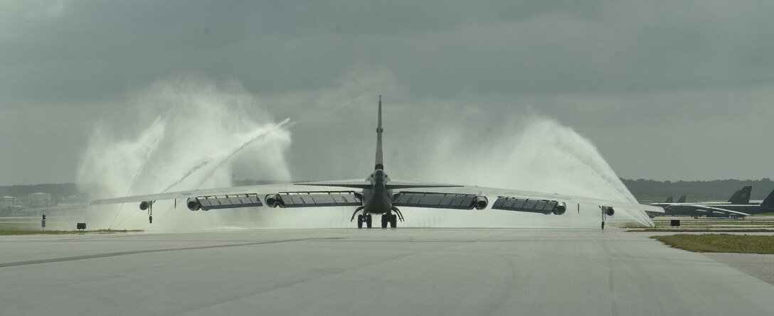 An Airman piloting a B-52H Stratofortress from Minot Air Force Base, N.D., taxis it through a clear water rinse system after landing March 11, 2014, on Andersen Air Force Base, Guam. The Airmen with the 69th Expeditionary Bomb Squadron deployed with the B-52s as part of the continuous bomber presence mission to maintain a prudent, long-standing deterrent capability throughout the Asia-Pacific region. (U.S. Air Force photo by Airman 1st Class Emily A. Bradley/Released)