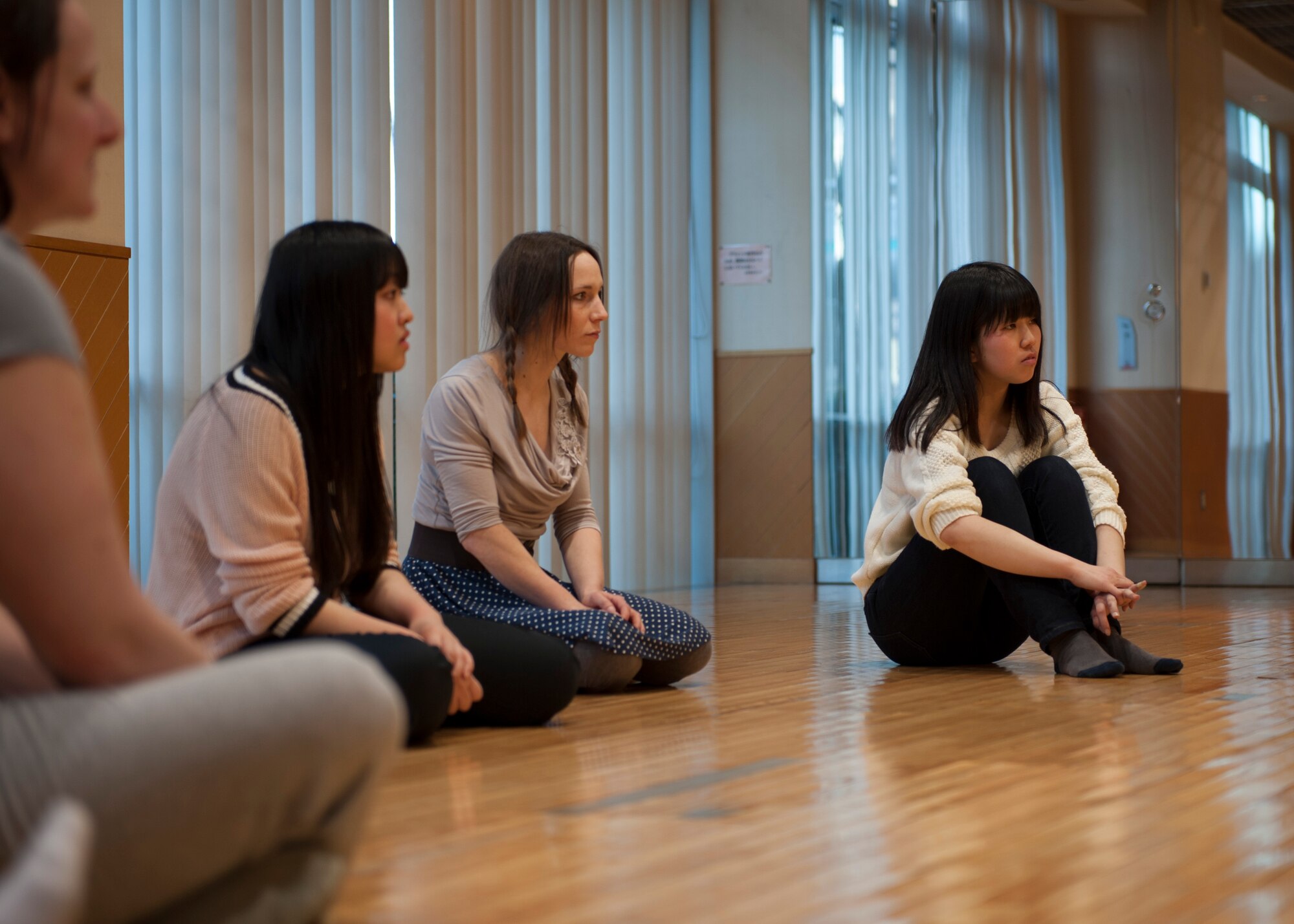Participants watch intently while a move is demonstrated during a self-defense class Mar. 10, 2014, at the Tachikawa Women’s Center AIM in Tachikawa, Japan. The Mrs. Sakura Organization, which focuses on education, community service and women’s empowerment, started offering various classes taught by its membership to the community surrounding Yokota Air Base, Japan. (U.S. Air Force photo by Senior Airman Desiree Economides/Released)