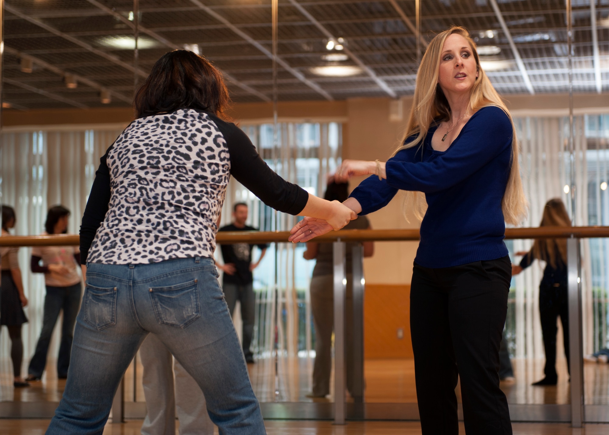 Kristi McFadden, Mrs. Sakura 2013, points out hand positioning during a self-defense class Mar. 10, 2014, at the Tachikawa Women’s Center AIM in Tachikawa, Japan. The Mrs. Sakura Organization offered this class as part of its community outreach in the community surrounding Yokota Air Base, Japan. (U.S. Air Force photo by Senior Airman Desiree Economides/Released)