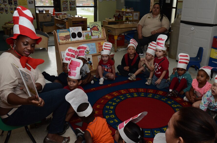 Tyeshia Bray, a volunteer during National Education Association’s Read Across America Day, reads “Green Eggs and Ham” by Dr. Seuss to children attending the Andersen Child Development Center March 3, 2014, on Andersen Air Force Base, Guam. Read Across America Day is a day to encourage reading as well as an observance in the United States held on the school day closest to March 2, the birthday of Dr. Seuss. (U.S. Air Force photo by Airman 1st Class Emily A. Bradley/Released)