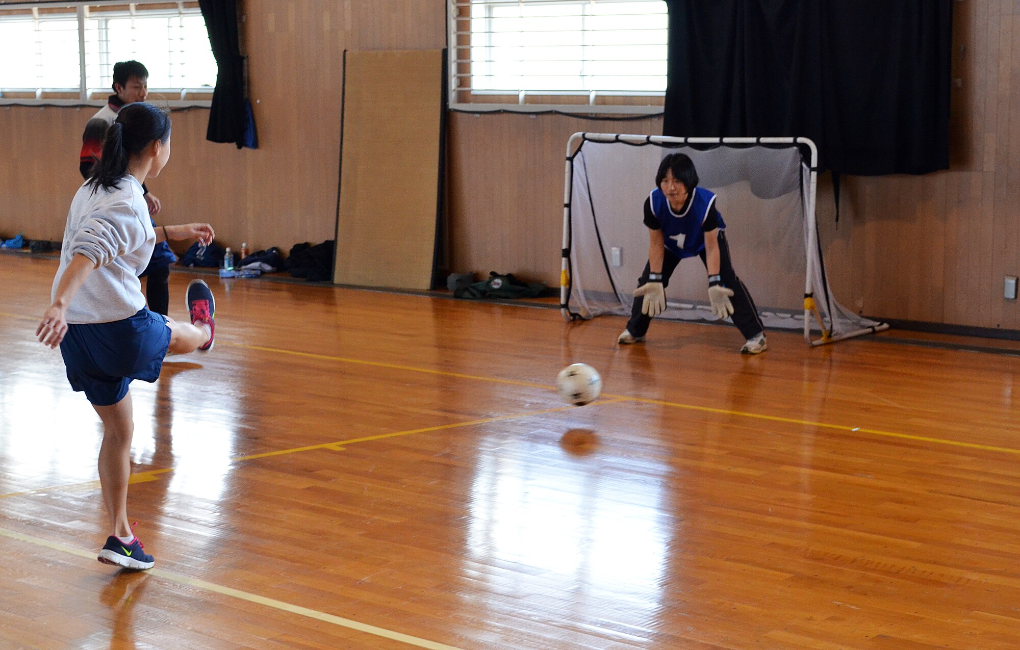 Staff Sgt. Hailie Reyes, 374th Logistics Readiness Squadron unit deployment manager, tries for a goal during a bilateral soccer game between NCO's from Yokota Air Base, Japan, and their counterparts in the Japanese Air Self Defense Force at Komaki Air Base, Japan, March 7, 2014.  The game helped build stronger relationships between the NCO's and their hosts as part of a bilateral exchange program, during which eight Non-Commissioned Officers from Yokota traveled to Komaki to observe how their JASDF counterparts conduct their mission and to learn more about Japanese culture. (U.S. Air Force photo by Tech. Sgt. Christopher Marasky/Released)