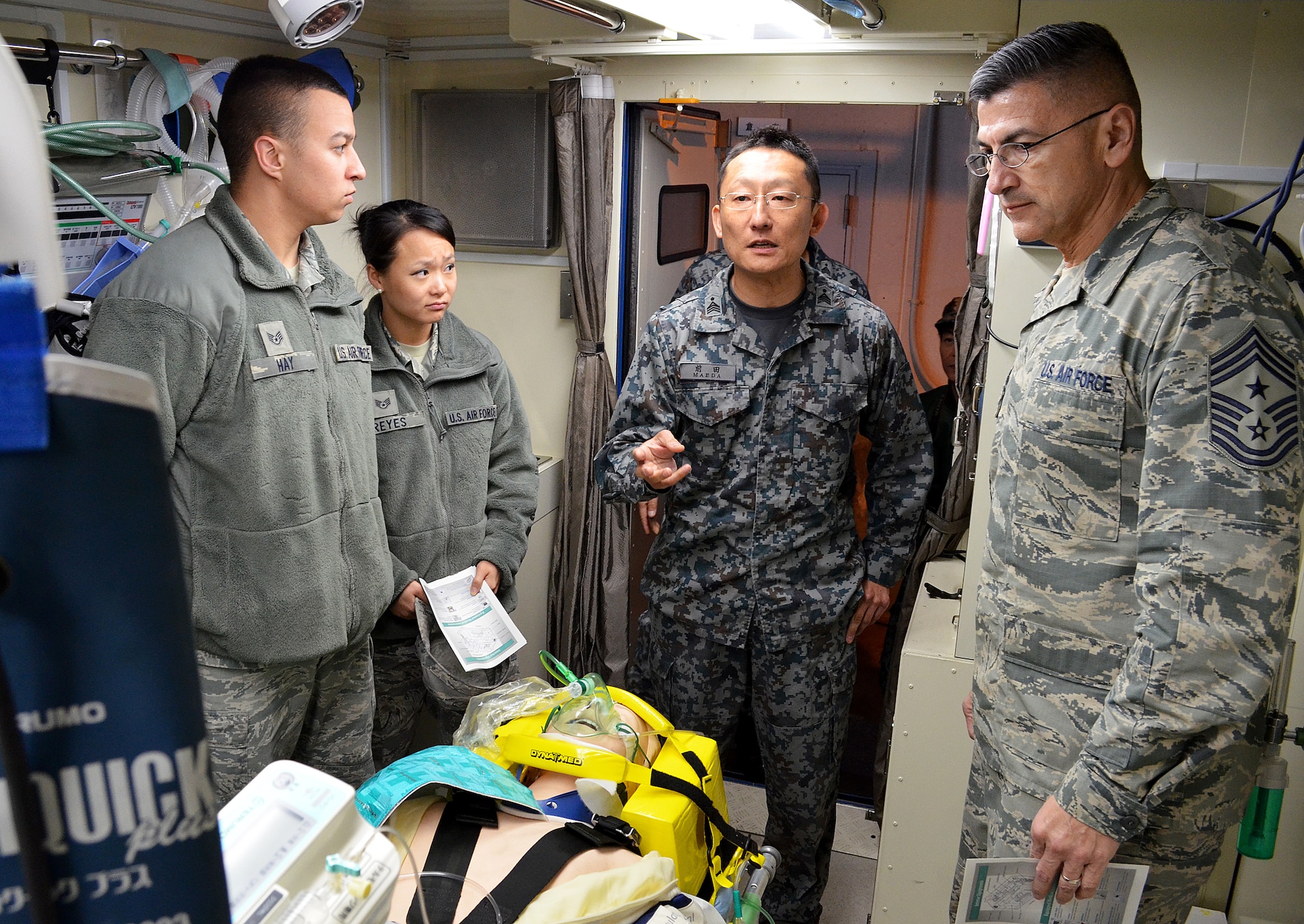 Chief Master Sgt. Manuel Roblesreynoso, 374th Airlift Wing command chief, and Non-Commissioned Officers from Yokota get a briefing from the Japanese Air Self Defense Forces Aeromedical Evacuation Squadron at Komaki Air Base, Japan, March 5, 2014.  The NCO's from Yokota were briefed on the AMES unique intensive care aeromedical evacuation pod, which loads into the back of a C-130 Hercules aircraft, the only of its type in the world. (U.S. Air Force photo by Tech. Sgt. Christopher Marasky/Released)