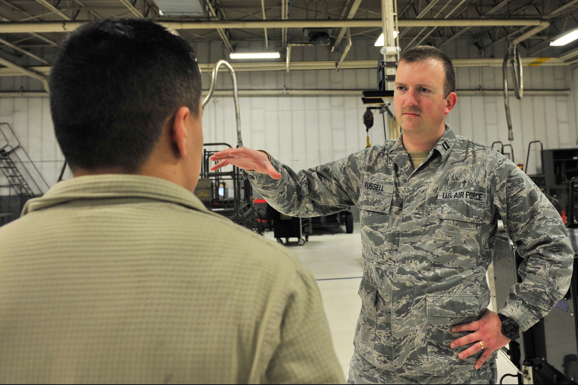 Chaplain (Capt.) Thomas Fussell, 354th Fighter Wing protestant chaplain, visits with a member of the 354th Maintenance Squadron aerospace ground equipment shop, March 6, 2014 Eielson Air Force Base, Alaska. Spiritual fitness is one of the four pillars of resiliency intended to enhance the overall well-being of an Airman. (U.S. Air Force photo/Senior Airman Ashley Nicole Taylor/Released)