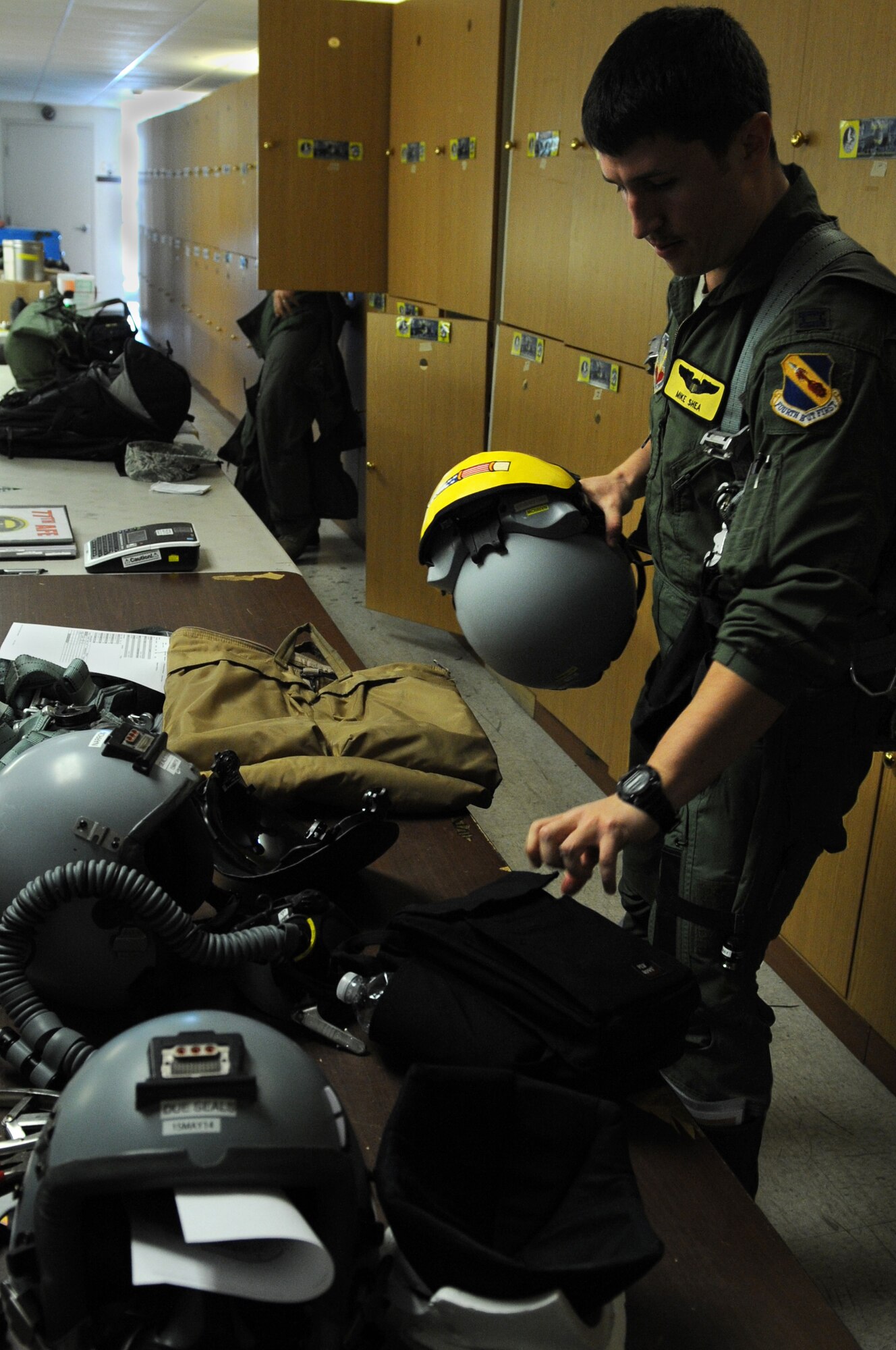 U.S. Air Force Capt. Mike Shea, 336th Fighter Squadron F-15E Strike Eagle pilot from Seymour Johnson Air Force Base, N.C., grabs his flight equipment prior to a Red Flag 14-2 mission March 13, 2014, at Nellis AFB, Nev. Shea and his fellow aircrew members rely on the aircrew flight equipment technicians to ready their essential safety gear before every flight in the Strike Eagle. (Air Force photo/Staff Sgt. Chuck Broadway)