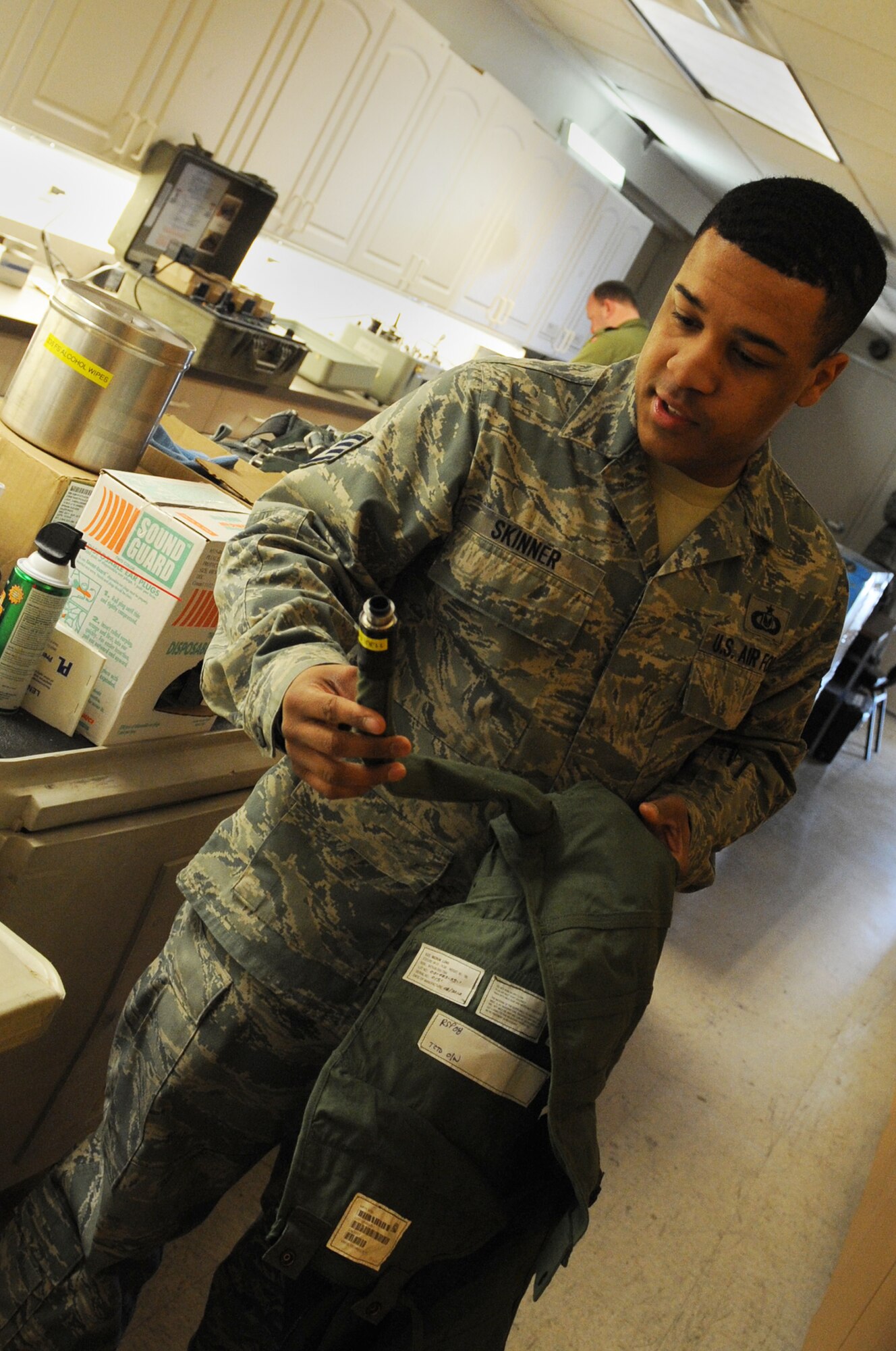U.S. Air Force Staff Sgt. Kendrick Skinner, 4th Operations Support Squadron aircrew flight equipment craftsman from Seymour Johnson Air Force Base, N.C., inspects a G-suit March 13, 2014, at Nellis AFB, Nev. Skinner helped maintained equipment readiness for more than 25 aircrew members from Seymour Johnson AFB during Red Flag 14-2. (Air Force photo/Staff Sgt. Chuck Broadway)