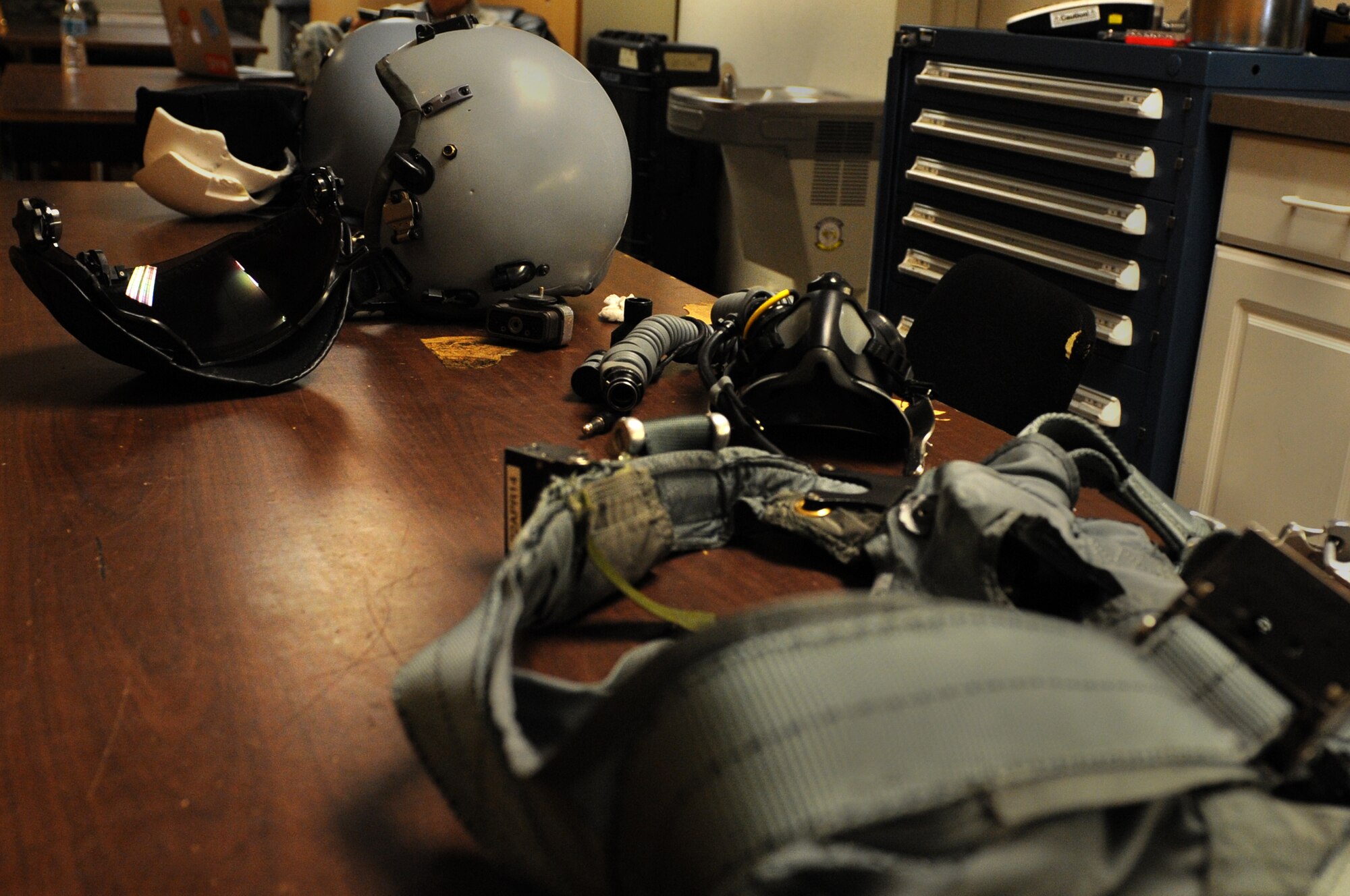 A helmet, mask and harness await inspection prior to a Red Flag 14-2 flight March 13, 2014, at Nellis Air Force Base, Nev. Aircrew flight equipment technicians inspect and ensure all equipment is in working order when aircrew members enter the facility to dress for a mission. (Air Force photo/Staff Sgt. Chuck Broadway)