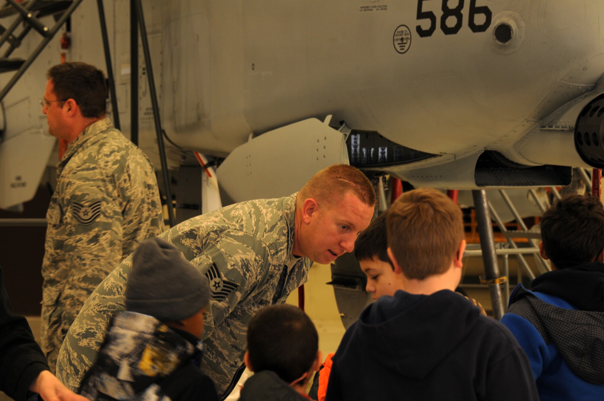 Tech Sgt. Leon Warrick with the 188th Aircraft Maintenance Squadron speaks with students from Fort Smith Union Christian Academy March 5, 2014, as part of the unit’s community outreach and base tour program. Students in grades 1st-4th toured the 188th’s hangar, Fire Emergency Services Office and Security Forces Squadron during their visit. (U.S. Air National Guard photo by Tech. Sgt. Josh Lewis/released)