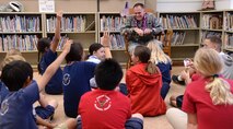 Col. Johnny Roscoe, 15th Wing commander, speaks with Hickam Elementary School 5th-graders after reading a book at Joint Base Pearl Harbor-Hickam, Hawaii, March 13, 2014. Roscoe read to the students as part of Read Across America, a National Educational Association program that celebrates reading in schools. Roscoe read “Tree Lady: The True Story of How One Tree-Loving Woman Changed a City Forever” by H. Joseph Hopkins. (U.S. Air Force photo/Staff Sgt. Alexander Martinez)