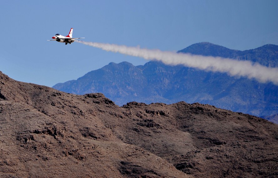 A U.S. Air Force Thunderbird makes a solo pass in a display of the F-16 Fighting Falcon aircraft’s capabilities during Indian Springs Appreciation Day March 11, 2014, at Creech Air Force Base, Nev. The team performs precision aerial maneuvers to exhibit the capabilities of modern high-performance aircraft to audiences throughout the world. (U.S. Air Force photo by Airman 1st Class C.C. /Released)