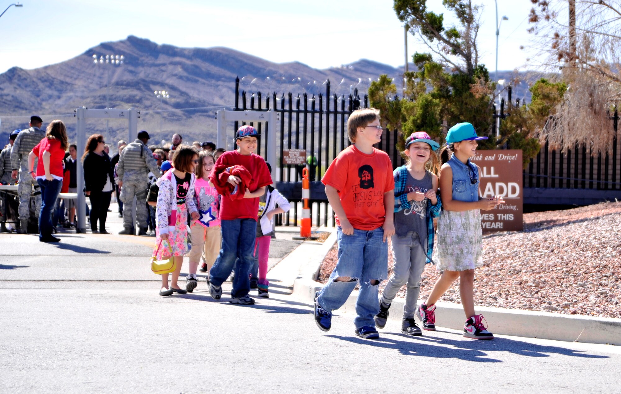 Children walk toward the flight line of Creech Air Force Base, Nev., for Indian Springs Appreciation Day March 11, 2014. The annual event showcases various Air Force missions to members of the Indian Springs community. (U.S. Air Force photo by Airman 1st Class C.C. /Released)