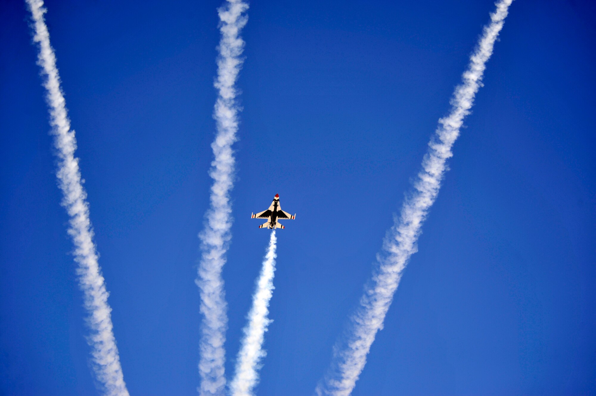 The U.S. Air Force Thunderbirds perform a high bomb burst maneuver to end their demonstration during Indian Springs Appreciation Day March 11, 2014, at Creech Air Force Base, Nev. The annual event gives Airmen the opportunity to showcase the base mission, aircraft, and build relationships with the Indian Springs populace. (U.S. Air Force photo by Airman 1st Class C.C. /Released)