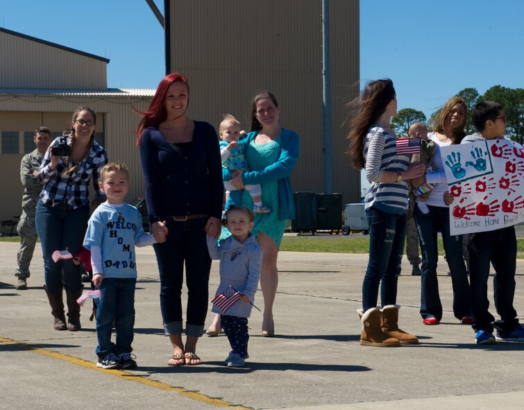 Hurlburt families wait for their loved ones to disembark from an aircraft on the flightline at the 9th Aircraft Maintenance Unit hangar during Operation Homecoming at Hurlburt Field, Fla., March 13, 2014. During OpHo families greet their Airmen when they return from deployed locations. (U.S. Air Force photo/Senior Airman Naomi Griego) 