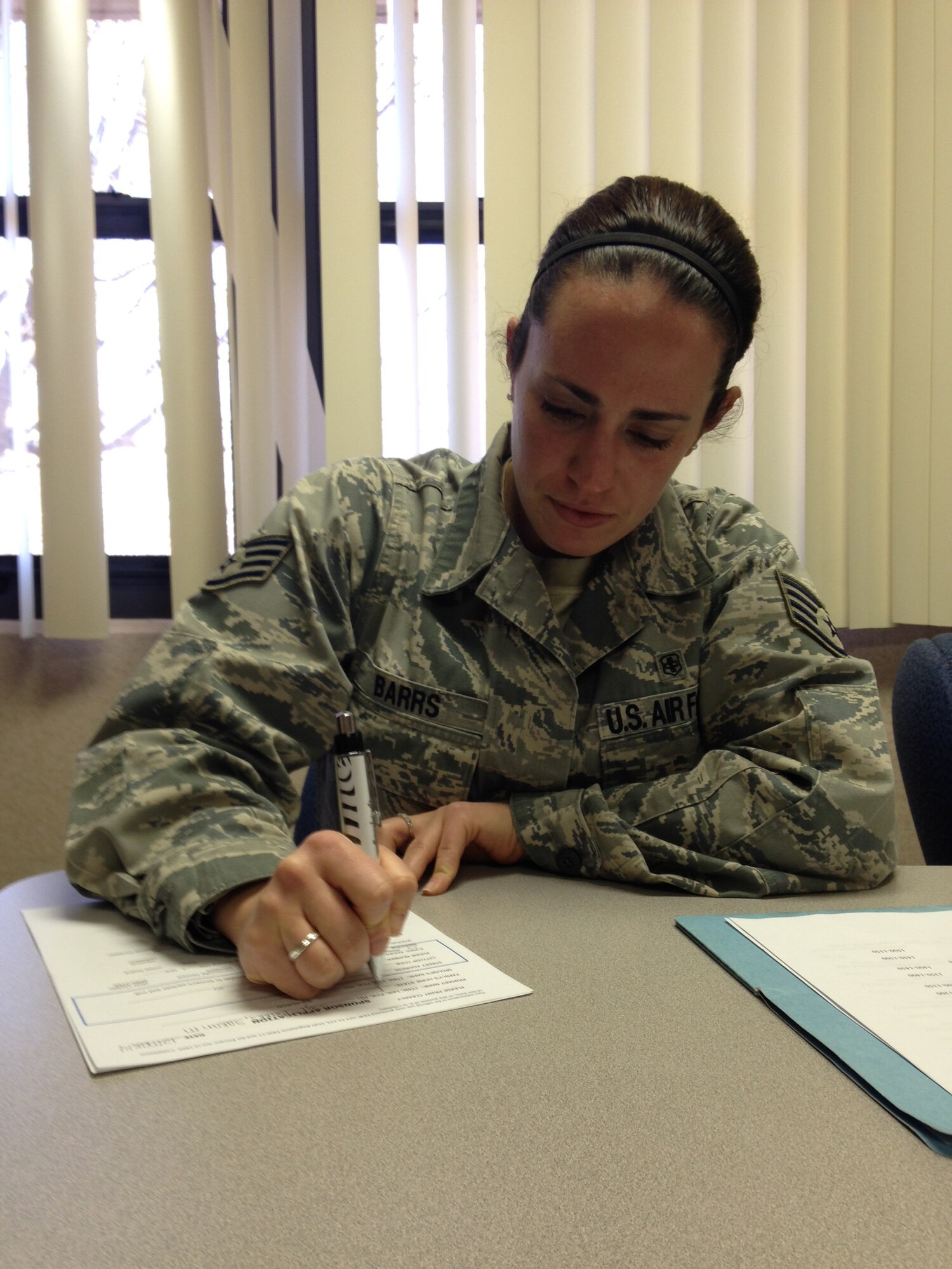 Staff Sgt. Sarah Barrs, a 19th Aerospace Medicine Squadron dental assistant, signs up for the Airman Sponsor and  Family Program during a Noncommissioned Officer Professional Enhancement class March 12, 2014, at Little Rock Air Force Base, Ark. The Airman Sponsor and Family Program that currently has 58 Airmen signed up, was designed to assist Airmen who are transitioning from basic military training and technical school to their first duty station. (courtesy photo)