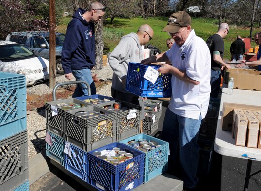 Beale first sergeants volunteer at a food drive in Penn Valley, Calif., March 11, 2014. The first sergeants palletized and then distributed thousands of pounds of goods to more than 120 families. (U.S. Air Force photo by Staff Sgt. Robert M. Trujillo/Released)
