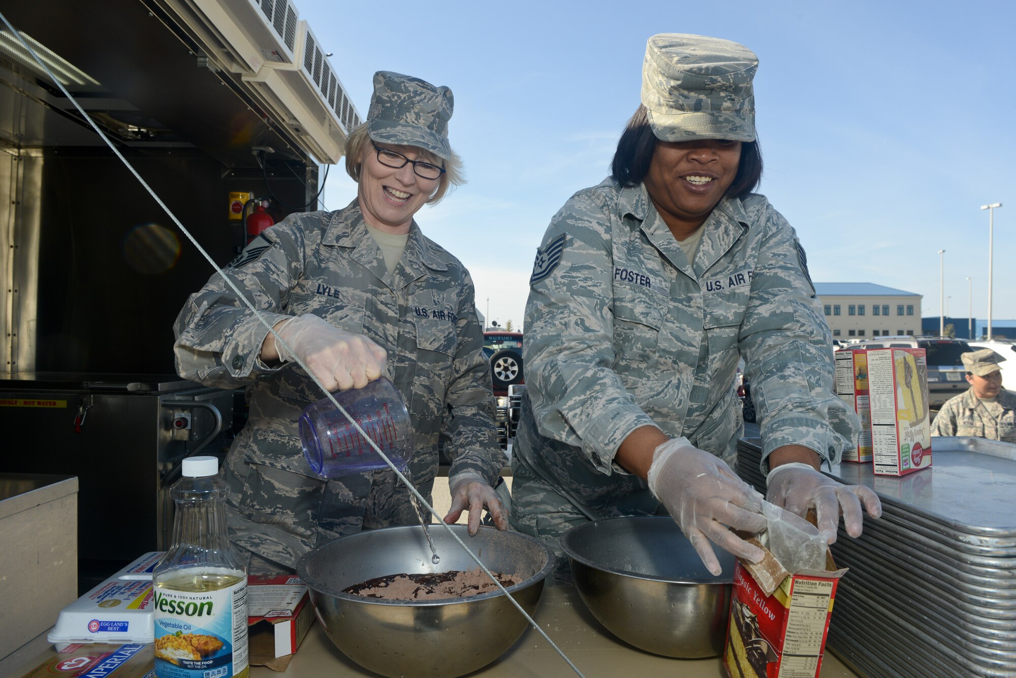 U.S. Air Force Master Sgt. Elisa Lyle, left, and Tech. Sgt. Jocelyn Foster, 116th Force Support Squadron, Services Flight (FSS/FSV), Georgia Air National Guard, Robins Air Force Base, Ga., mix ingredients in preparation for baking a cake in a Deployable Ready Mobile Kitchen Trailer (DRMKT) while training with the 136th FSS/FSV, Texas Air National Guard, at Naval Air Station Fort Worth Joint Reserve Base, Texas, Feb. 22, 2014. Members of the 116th FSS/FSV participated in the two-day training event in anticipation of receiving their own DRMKT in July 2014. (U.S. Air National Guard photos by Master Sgt. Charles Hatton/Released)
