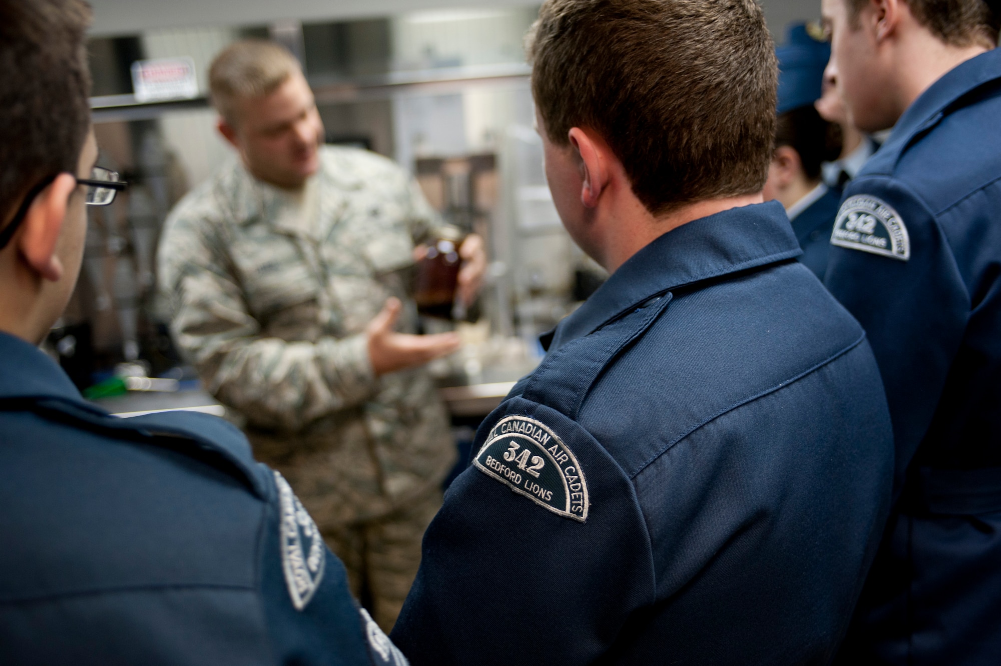 Royal Canadian Air Cadets from the 342nd Bedford Lions Squadron listen to a briefing at the 633rd Logistics Readiness Squadron during a tour of Langley Air Force Base, Va., March 12, 2014. The tour showed more than 30 cadets the U.S. military mission, teaching them about international partnerships. (U.S. Air Force photo by Airman 1st Class R. Alex Durbin/Released) (This image was cropped to emphasize subject)