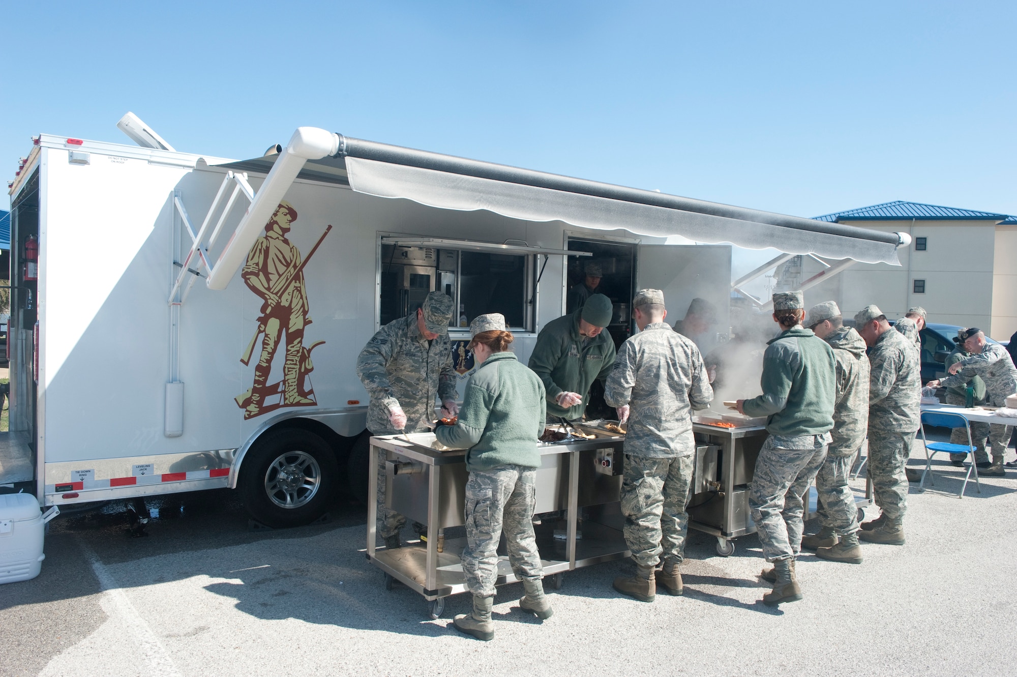 Members of the 136th Force Support Squadron, Services Flight (FSS/FSV), Texas Air National Guard, serve hot meals to Guardsmen during a unit training assembly while demonstrating the functionality of a newly assigned Deployable Ready Mobile Kitchen Trailer (DRMKT) to members of the 116th Force Support Squadron, Services Flight, Georgia Air National Guard, Robins Air Force Base, at Naval Air Station Fort Worth Joint Reserve Base, Texas, Feb. 23, 2014. Members of the 116th FSS/FSV participated in a two-day training event in anticipation of receiving their own DRMKT in July 2014. (U.S. Air National Guard photos by Master Sgt. Charles Hatton/Released)