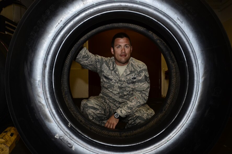 Staff Sgt. Tyler Ambrose, 36th Maintenance Squadron, poses with a B-52 wheel Feb. 26, 2014, at Anderson Air Base, Guam. Last year, Ambrose submitted a B-52 wheel shipping and rebuild idea through the Every Dollar Counts program saving the Air Force nearly $124,000. The savings helped fund local shortfalls and other unfunded mission requirements. (U.S. Air Force photo/ Airmen 1st Class Amanda Morris)