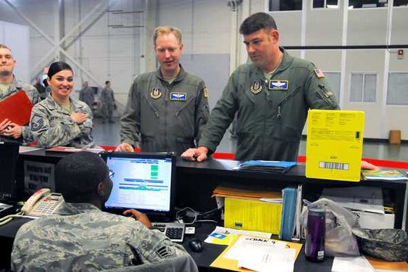 Master Sgt. Sarah Espinoza, left, Maj. Jason De Kruyf, middle, and Lt. Col. Hans Bley go through the medical eligibility station during Operation Cold Snap March 5 at Joint Base Lewis-McChord, Wash. (Jake Dorsey/Northwest Guardian)