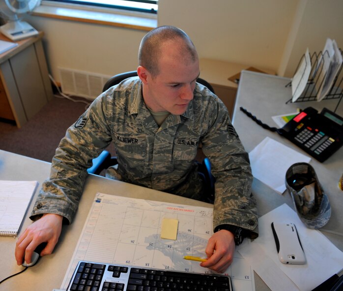 Staff Sgt. James Kliewer, 673rd Contracting Squadron, researches contracts for potential cost saving opportunities Feb. 24, 2014, at Joint Base Elmendorf-Richardson, Alaska. Last year, Kliewer saved the Air Force $246,000 when he discovered a more cost effective way to purchase Potassium Acetate deicing fluid. (U.S. Air Force photo/Airmen 1st Class Tammie Ramsouer)