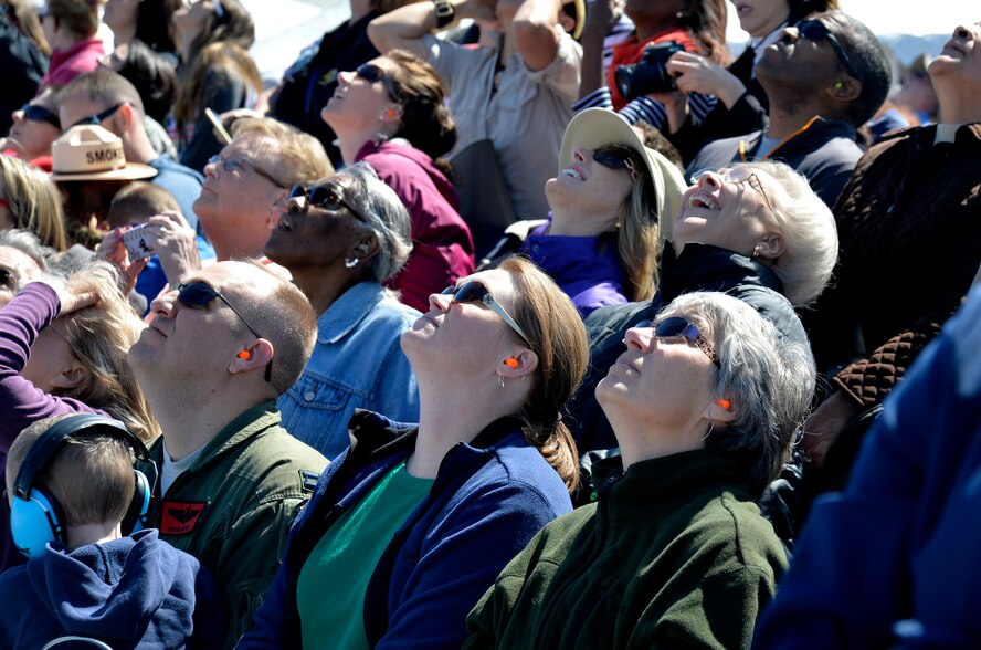 Residents from the local community enjoy the U.S. Air Force Thunderbirds demonstration during Indian Springs Appreciation Day March 11, 2014, at Creech Air Force Base, Nev.  During the event the Indian Springs populace were able to watch Airmen demonstrate loading techniques on the MQ-9  Reaper, enjoy food and drinks, as well as visit booths set up by various Air Force members and associations. (U.S. Air Force photo by Staff Sgt. A.K./Released)
