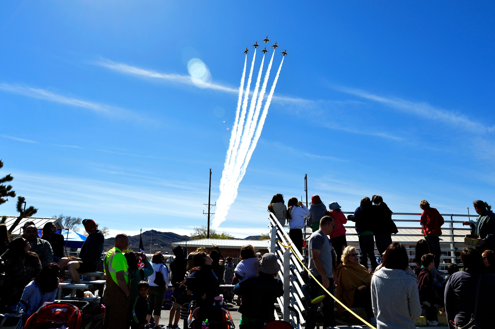 The U.S. Air Force Thunderbirds begin their demonstration by flying over the crowd during Indian Springs Appreciation Day March 11, 2014, at Creech Air Force Base, Nev. The team performs precision aerial maneuvers to exhibit the capabilities of modern high-performance aircraft to audiences throughout the world. (U.S. Air Force photo by Staff Sgt. A.K./Released)