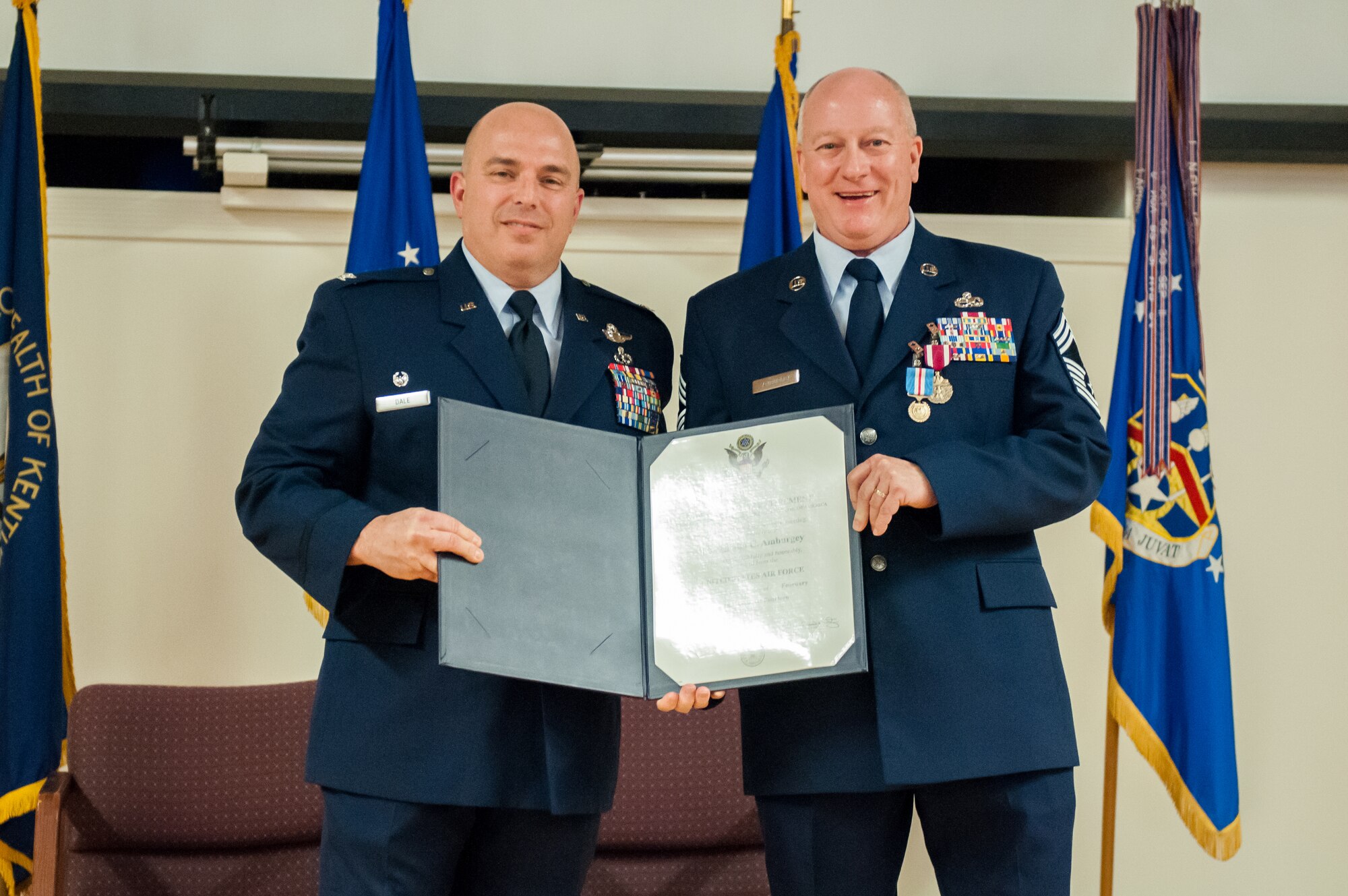 Chief Master Sgt. Jim Amburgey (right) receives a certificate of retirement from Col. Kenneth Dale, commander of the 123rd Maintenance Group, during his retirement ceremony at the Kentucky Air National Guard Base in Louisville, Ky., on Jan. 12, 2014. Amburgey served for more than 38 years. (U.S. Air National Guard photo by Staff Sgt. Vicky Spesard)