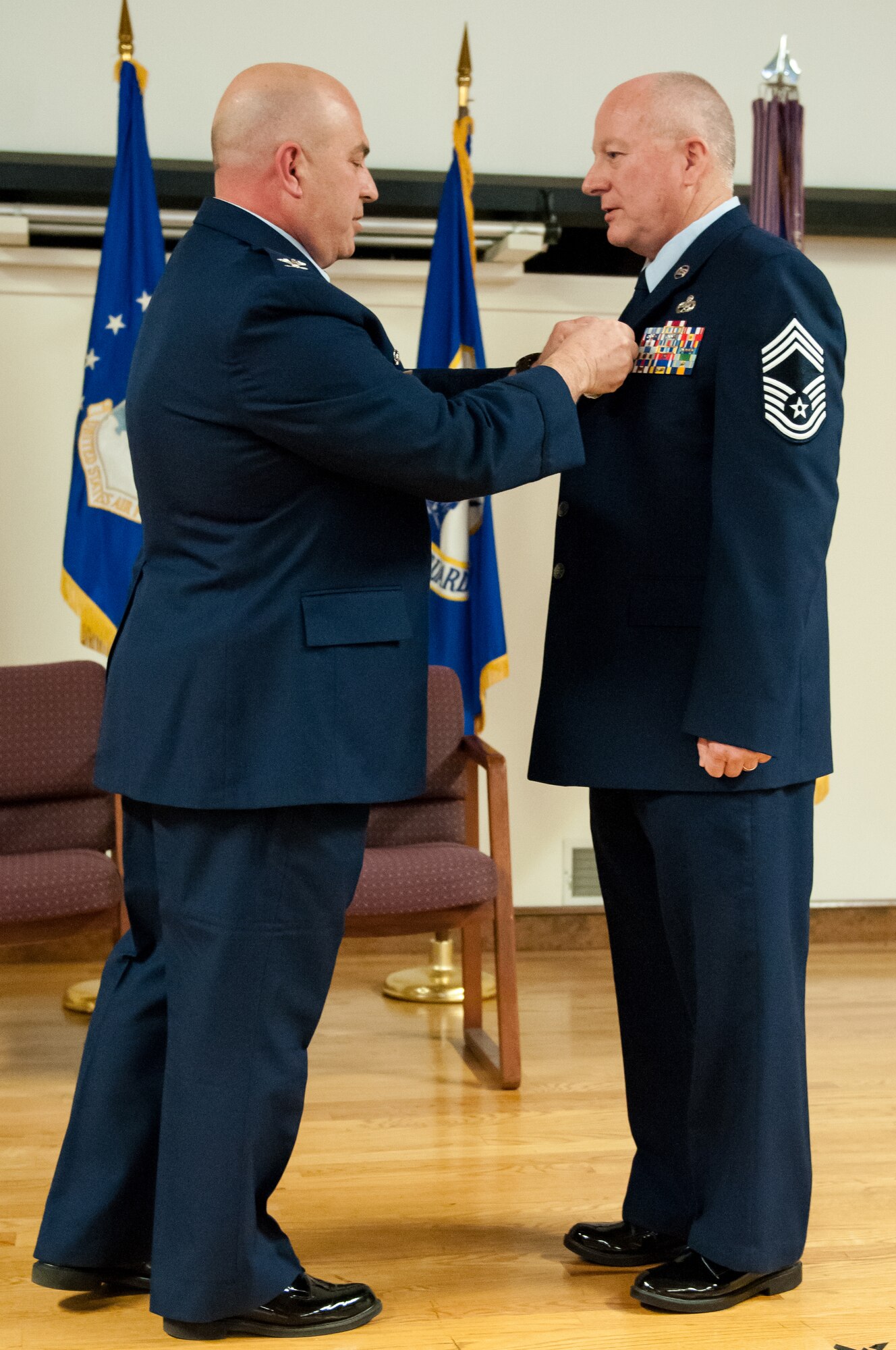 Col. Kenneth Dale (left), commander of the 123rd Maintenance Group, pins the Meritorious Service Medal to the jacket of Chief Master Sgt. Jim Amburgey during Amburgey's retirement ceremony at the Kentucky Air National Guard Base in Louisville, Ky., on Jan. 12, 2014. Amburgey served for more than 38 years. (U.S. Air National Guard photo by Staff Sgt. Vicky Spesard)