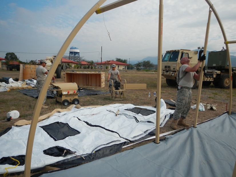 Members of Joint Task Force-Bravo’s Army Forces Battalion participate in a field sanitation training exercise assembling the E-lite Camp System, March 5, 2014.  The E-Lite Camp System provides military members the ability to take showers and perform personal hygiene while living in field conditions.  (Photo by U.S. Army Spc. Cory Cantlay)