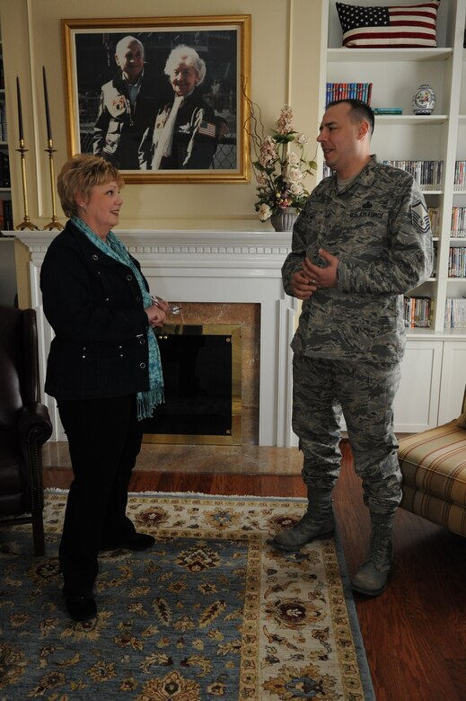 Janet Grampp, Andrews Fisher House manager, and Master Sgt. Christ Sweet, Military & Family Support Center noncommissioned officer in charge, catch up on their lives in the Fisher House sitting room March 5, 2014, at Joint Base Andrews, Md. Grampp and Sweet met in 2008 when the Sweet family stayed at the home for three months while Sweet’s wife, Jessica, received cancer treatment at Walter Reed National Military Medical Center. (U.S. Air Force photo by Aimee Fujikawa)
