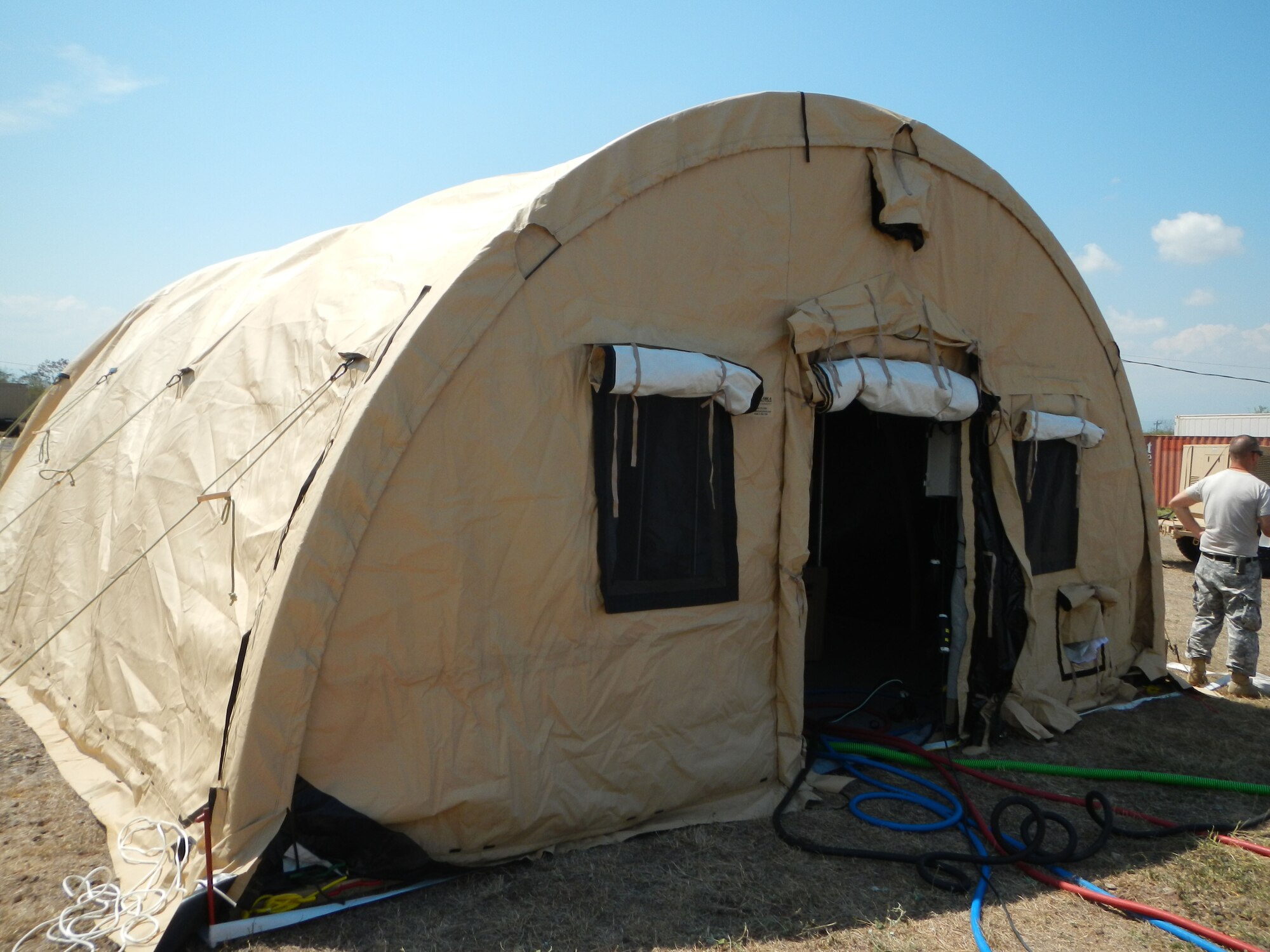 Members of Joint Task Force-Bravo’s Army Forces Battalion participate in a field sanitation training exercise assembling the E-lite Camp System, March 5, 2014.  The E-Lite Camp System provides military members the ability to take showers and perform personal hygiene while living in field conditions.  (Photo by U.S. Army Spc. Cory Cantlay)