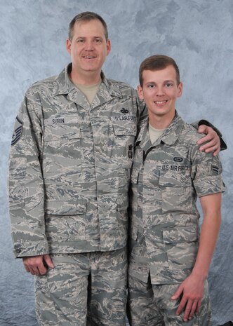 Master Sgt. Joseph Surin, 9th Security Forces Squadron NCO in charge of training, and son Airman 1st Class Darren Surin, 9th Intelligence Squadron, pose for a photo at Beale Air Force Base, Calif., March 12, 2014. Joseph has served twenty years as a security forces member, while Darren is approaching his one year mark in the intelligence career field. (U.S. Air Force photo by Mr. Robert Scott/Released)