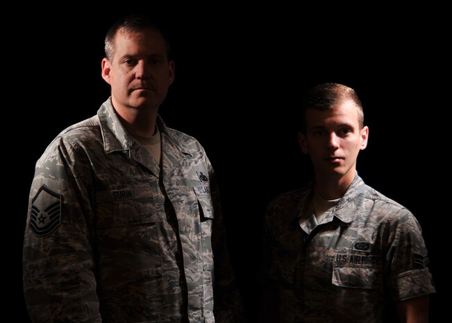 Master Sgt. Joseph Surin, 9th Security Forces Squadron NCO in charge of training, and son Airman 1st Class Darren Surin, 9th Intelligence Squadron, pose for a photo at Beale Air Force Base, Calif., March 12, 2014. Joseph and Darren are stationed together at Beale. (U.S. Air Force photo by Mr. Robert Scott/Released)