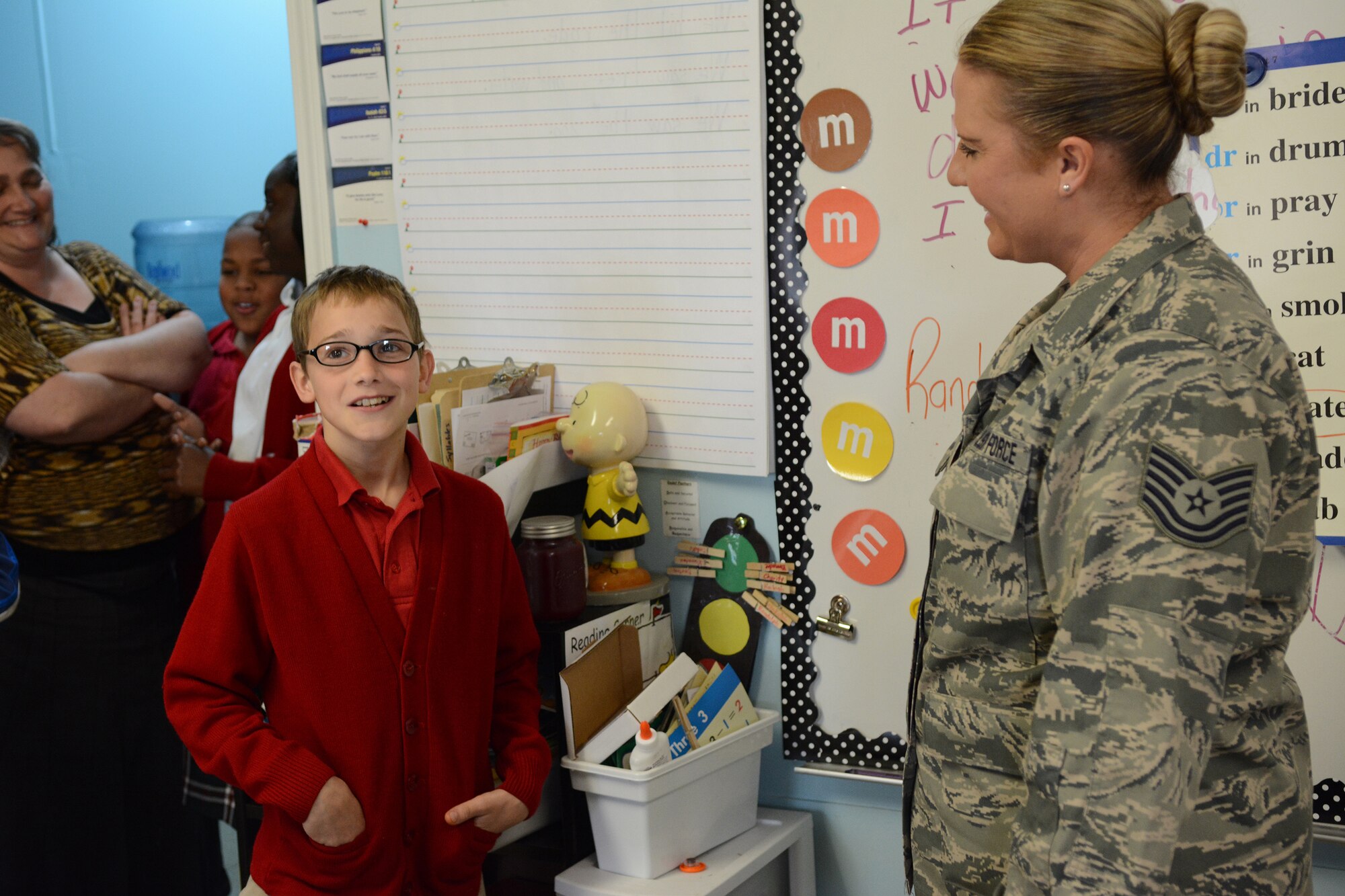 Tech. Sgt. Michelle Reed, 153rd Medical Group optometry technician, watches the joy a Lighthouse Christian Academy student has after she gives a pair of glasses to him during Cajun Care 2014 in Abbeville, La., March 6, 2014. Air National Guard and Navy personnel visited the school to examine the students' and teachers' eyes, and later returned with glasses for all who needed them. (Air National Guard photo by Senior Airman Andrea F. Liechti)