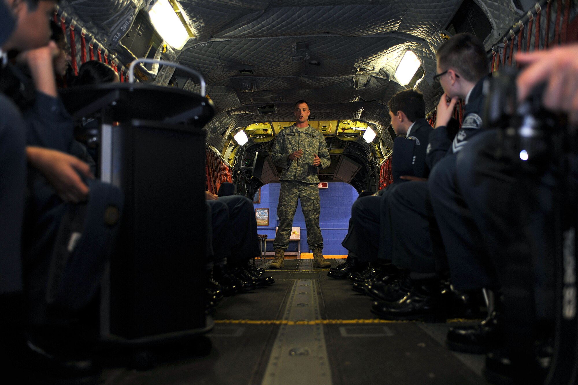 U.S. Army Staff Sgt. Owen Cunningham,  A Company, 2nd Battalion, 210th Aviation Regiment, 128th Aviation Brigade senior instructor/writer, conducts a tour of the inside of cargo helicopter maintenance trainer during a visit from Canadian Air Cadets from the 180th Mosquito Squadron at Fort Eustis, Va., March 12, 2014. The 2-210th Avn. Rgt. conducts Advanced Individual Training, noncommissioned officer advance courses, and warrant officer maintenance training for the CH-47 Chinook and UH-60 Black Hawk helicopters. (U.S. Air Force photo by Staff Sgt. Katie Gar Ward/Released)

