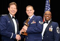 COLORADO SPRINGS, Colo. Staff Sgt. Shawn MacDonald, center, received his trophy for being recognized as the noncommissioned officer of the year from Col. Courtney Arnold, left, 302nd Airlift Wing commander, and Chief Master Sgt. Otis Jones, the wing’s command chief, during an awards banquet March 1 here. Other winners from the Air Force Reserve Command’s 302nd Airlift Wing included Senior Airman Paul Basirico, airman of the year, 302nd Aircraft Maintenance Squadron, Senior Master Sgt. Vicki Robertson, senior noncommissioned officer of the year, 302nd Force Support Squadron, first sergeant of the year was Master Sgt. Jayson Heeks, 52nd Airlift Squadron, company grade officer of the year was Capt. Craig Gulledge, 52nd AS (attached to the 302nd Aeromedical Staging Squadron and the field grade officer of the year was Lt. Col. Gregory  Berry, 302nd operations support squadron. MacDonald works for the 302nd FSS. The annual 302nd AW awards banquet is held to publicly recognize the outstanding achievements of individuals throughout the wing. (U.S. Air Force photo/Dennis Howk)