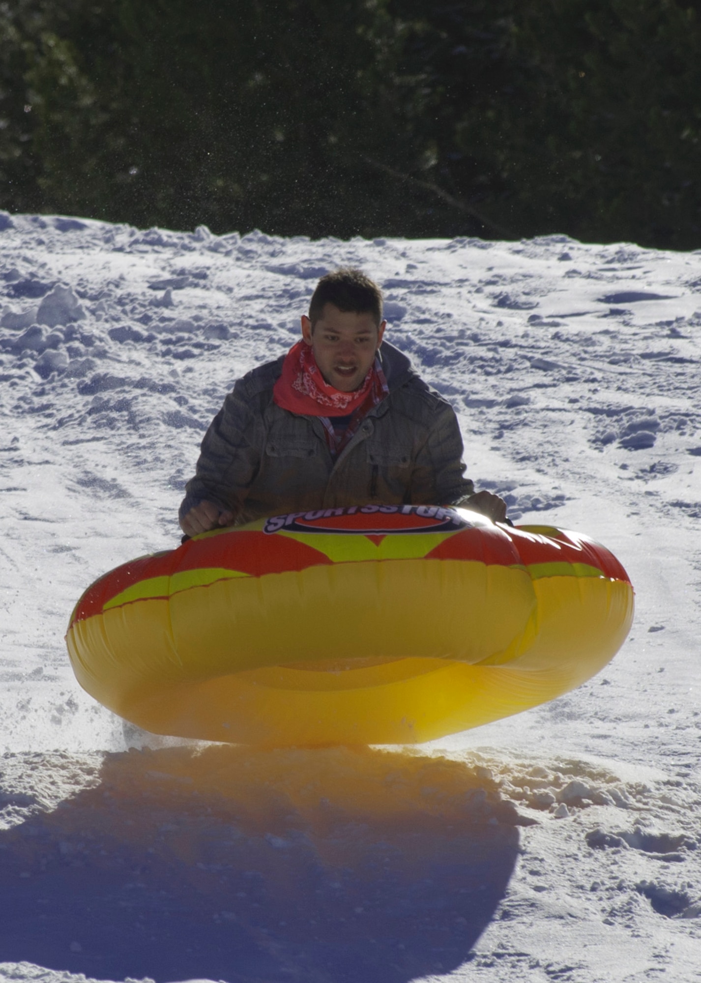 140308-F-ZZ999-001 Airman 1st Class Brandon Valle, 90th Missile Wing Public Affairs, takes air March 8 while riding an inner tube down a hill during an Outdoor Recreation trip. Outdoor Rec. took a group of 12 to the Happy Jack Recreational area, where the group broke off and went tubing, snow-shoe hiking or hung out around the bus for hot cocoa. (U.S. Air Force photo by Gary Sakura)